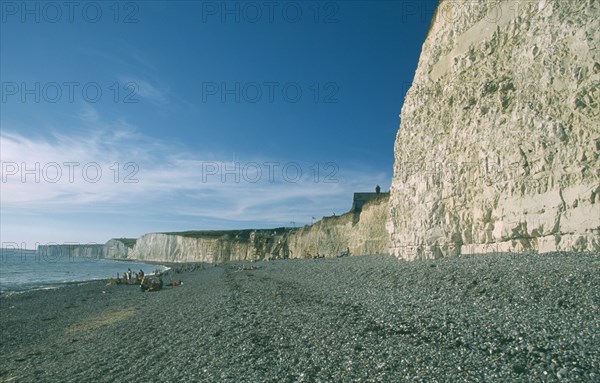 ENGLAND, East Sussex, Birling Gap, Occupied peeble beach and long section of cliff face.
