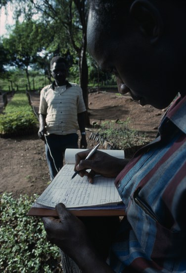 KENYA, Kamba Region, Forestry field assistant Joseph Wanjohia collecting Kamba dialect names and associations of trees.