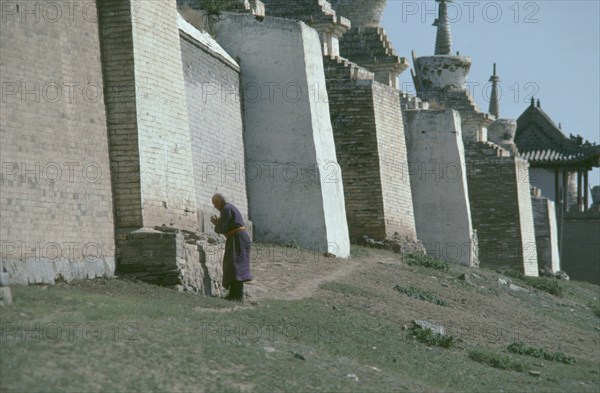 MONGOLIA, Central Gobi Province, Karakorum, Pilgrim circumnavigating city walls on site of ancient capital of Ghengis Khan.