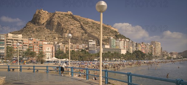 SPAIN, The Costa Blanca, Alicante. , Playa del Postiguet with Castillo de Santa Barbera rising behind.