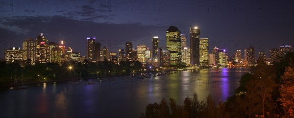 AUSTRALIA, Queensland, Brisbane, Panoramic view of the city across the Brisbane River as dusk falls.