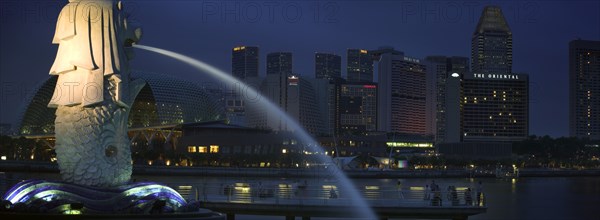 SINGAPORE, Merlion Statue, Night time view of the Esplanade - Theatres on the Bay complex from Merlion Park.