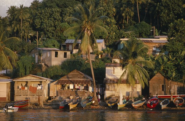 ST LUCIA, Soufriere, Town houses with lush vegetation behind.