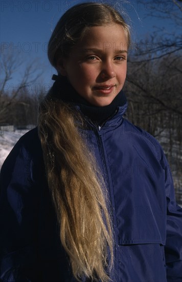 CHILDREN, Portraits, "Portrait of young girl with long blonde hair outdoors, dressed for cold weather."