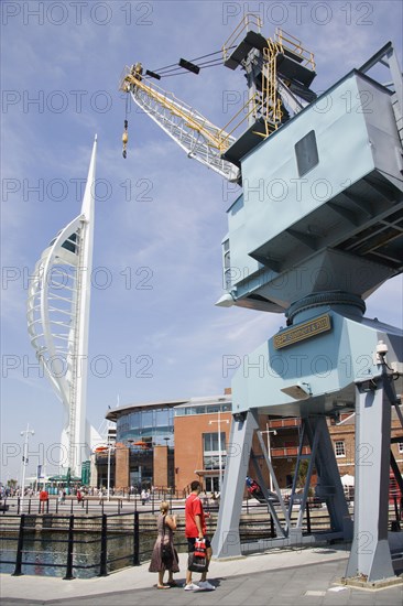ENGLAND, Hampshire, Portsmouth, The Spinnaker Tower the tallest public viewing platforn in the UK at 170 metres on Gunwharf Quay with an old dockside crane in the foreground