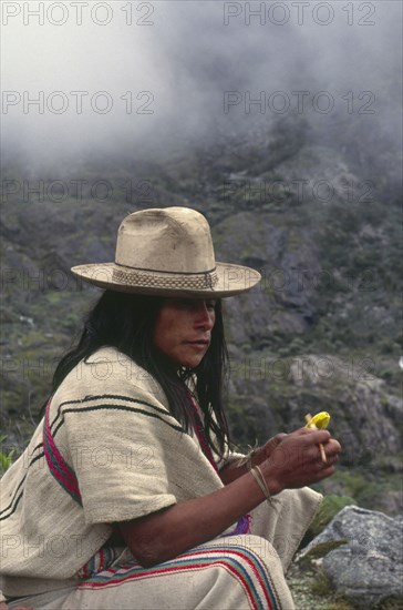 COLOMBIA, Santa Marta, Sierra Nevada , "Ica Indian taking coca, gourd in left hand has calcium which is mixed with coca leaves in the mouth."