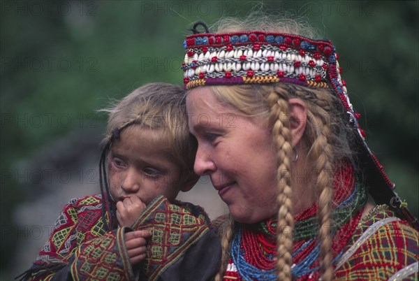 PAKISTAN, North West Frontier Province, Rumbur valley, European anthropologist with Kalash boy.