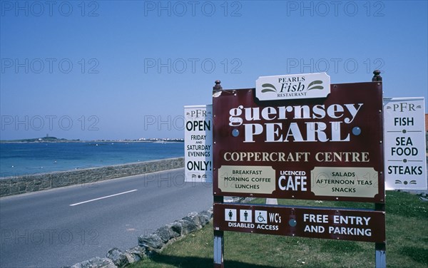 UNITED KINGDOM, Channel Islands, Guernsey, St Peters.The Guernsey Pearl and Coppercraft centre sign on side of road.