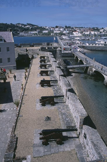UNITED KINGDOM, Channel Islands, Guernsey, St Peter Port. Castle Cornet. View above Cannons lined up next to castle wall.