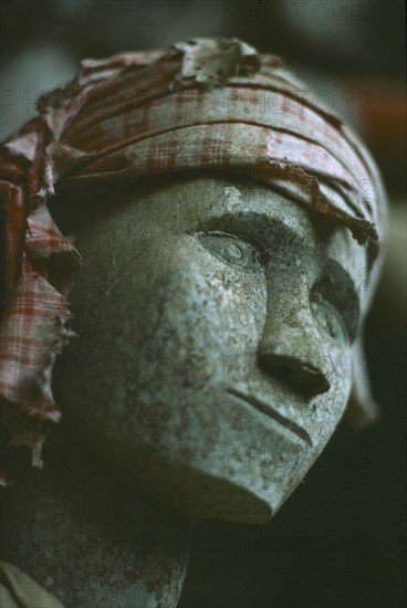 INDONESIA, Sulawesi, Face detail of Toraja wooden funeral effigy or Tau Tau placed outside the grave to represent the spirit of the deceased.