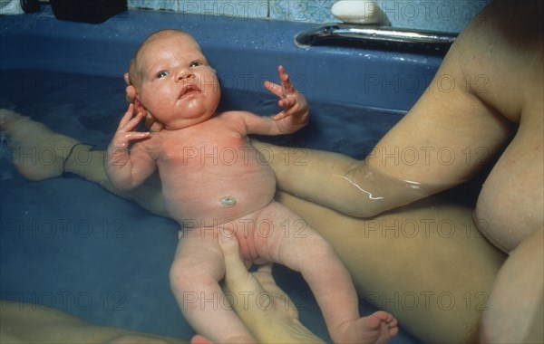 CHILDREN, Bathing, Five day old baby girl bathing with mother.