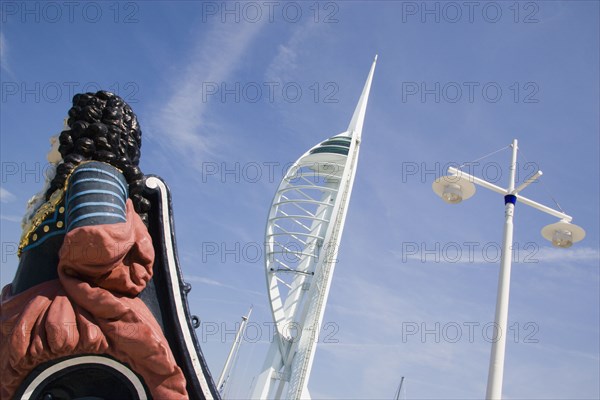 ENGLAND, Hampshire, Portsmouth, The Spinnaker Tower the tallest public viewing platforn in the UK at 170 metres on Gunwharf Quay with old ships bowsprit figurehead in the foreground