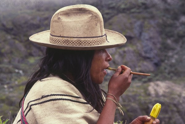COLOMBIA, Santa Marta, Sierra Nevada , "Ica indian taking coca, gourd in left hand has calcium which is mixed with coca leaves in the mouth."