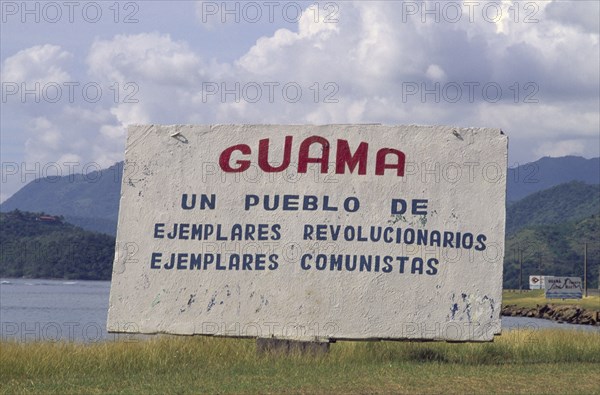 CUBA, Guama, "Sign welcoming people to the town, including revolutionary writings."