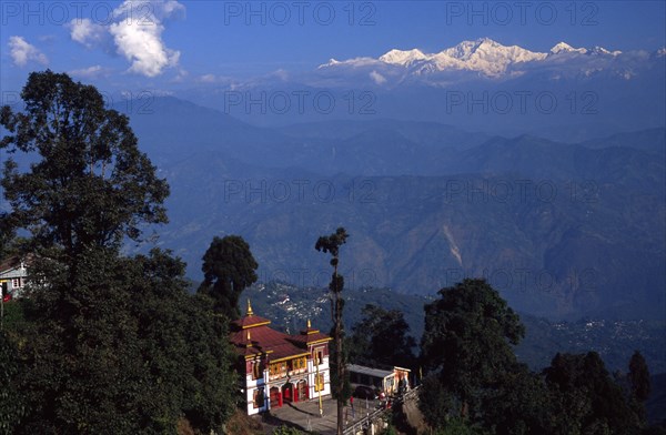 INDIA, West Bengal, Darjeeling, "Bhutia Busty Gompa and Mount Kanchenjunga beyond the Buddhist monastery, which houses the original copy of the Tibetan book of the dead, looks out over the Himalayan foothills and on to the peaks of the world's third highest mountain"
