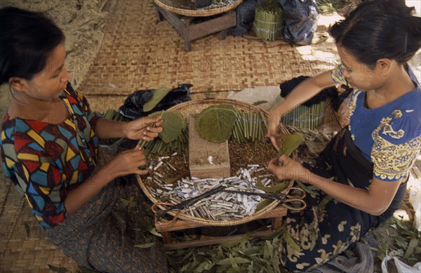 MYANMAR, Bago, Female workers rolling cheroots by hand inside factory workplace.