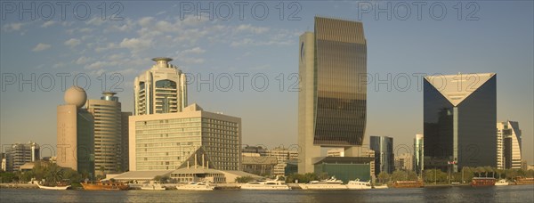 UAE, Dubai., "View of architecture along the Creek including The Etisalat Building, The Hilton, The National Bank, and The Chamber of Commerce & Industry."