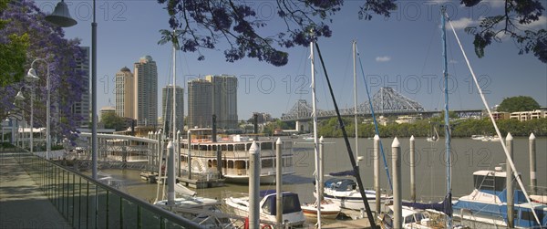 AUSTRALIA, Queensland, Brisbane, "Pleasure boats moored on the Brisbane River, with the Kookaburra Queens I and II, restored paddle steamers, in the middle distance and the Story Bridge in the background."