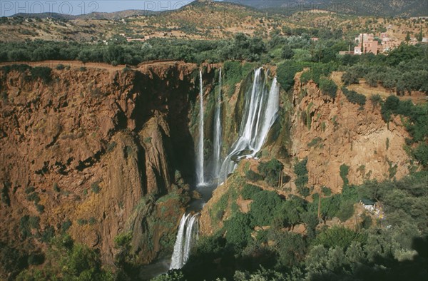 MOROCCO, Middle Atlas, Cascades d’Ouzoud, Waterfalls of the Olives.  View towards top of multiple falls cascading over rocks into natural pools.