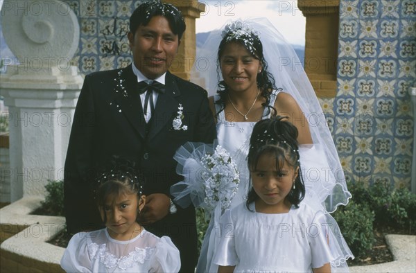 BOLIVIA, La Paz, "Wedding in El Monticulo. Bride, Groom and two young bridesmaids."