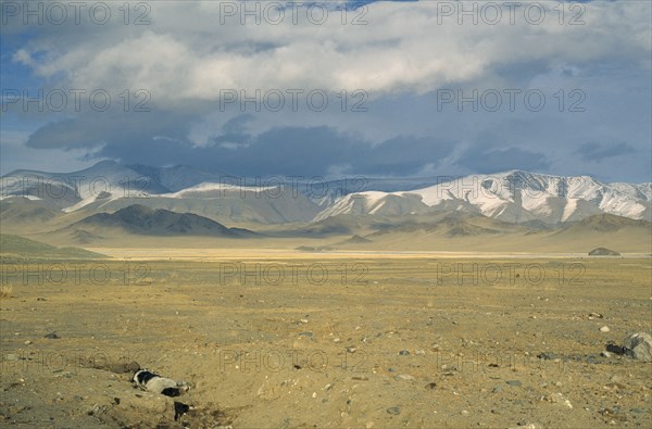MONGOLIA, Bayan Olgii Province, Open steppe lands near Kazakh inhabited Deluun. Dead animal in a ditch lower left of the image.
