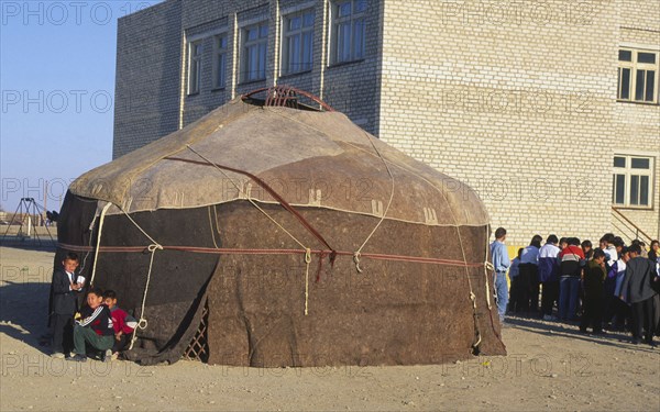 KAZAKHSTAN, Kyzlorda, Yourt in Kazakh playground with groups of children nearby.