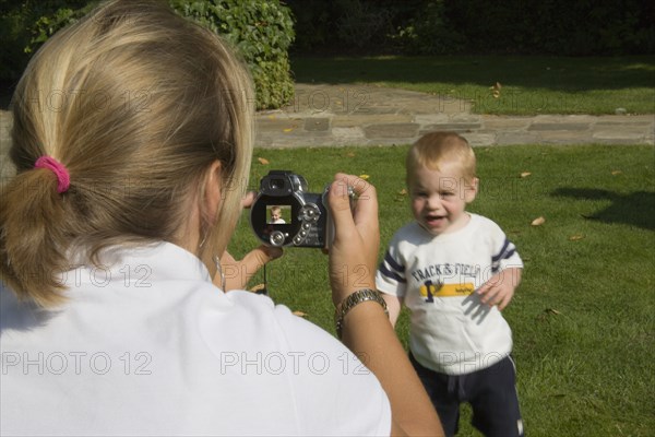 MEDIA , Cameras, Digital, Mother taking a digital photograph of her son