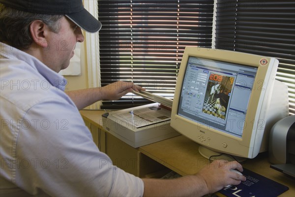 MEDIA , Film, Digital, Man using a flatbed scanner