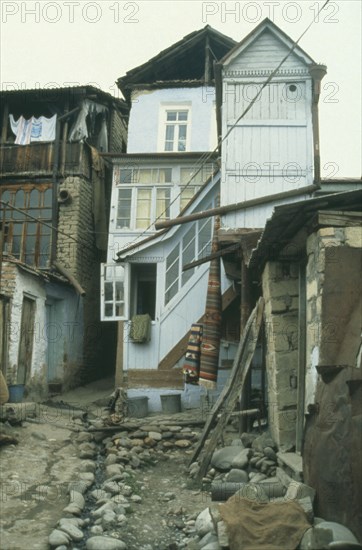 RUSSIA, Dagestan, Narrow street with central open drain and traditional housing.