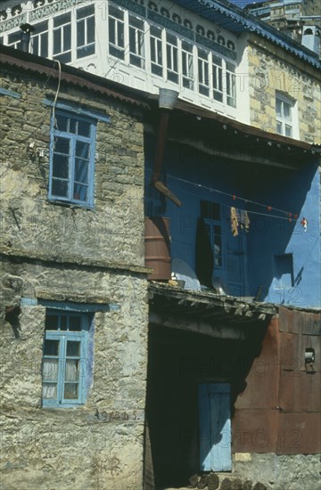 RUSSIA, Dagestan, Koubachi, Traditional housing with pancakes of manure drying for use as fuel outside.