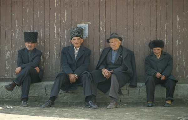 RUSSIA, Dagestan, Koubachi, ‘Gooderan’ meeting place.  Four men sitting along wall.