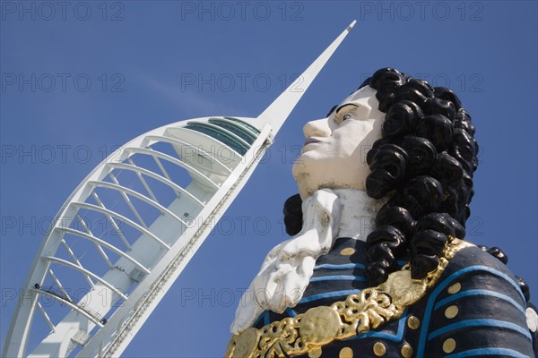 ENGLAND, Hampshire, Portsmouth, The Spinnaker Tower the tallest public viewing platforn in the UK at 170 metres on Gunwharf Quay with old ships bowspit figurehead in the foreground