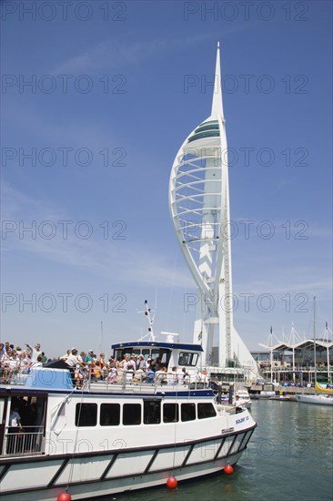 ENGLAND, Hampshire, Portsmouth, The Spinnaker Tower the tallest public viewing platforn in the UK at 170 metres on Gunwharf Quay with harbour tour boat entering the moorings