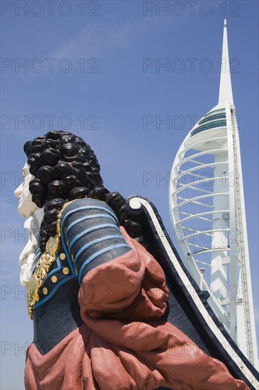 ENGLAND, Hampshire, Portsmouth, The Spinnaker Tower the tallest public viewing platforn in the UK at 170 metres on Gunwharf Quay with old ships bowsprit figurehead in the foreground