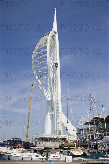 ENGLAND, Hampshire, Portsmouth, The Spinnaker Tower the tallest public viewing platforn in the UK at 170 metres on Gunwharf Quay with moorings in the foreground