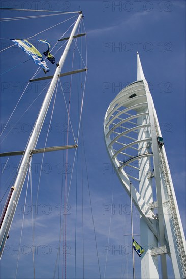 ENGLAND, Hampshire, Portsmouth, The Spinnaker Tower the tallest public viewing platforn in the UK at 170 metres on Gunwharf Quay with yachts mast in the foreground