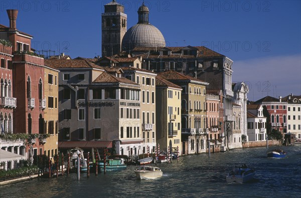 ITALY, Veneto, Venice, The Grand Canal and water traffic overlooked by the Hotel Continental with dome of San Geremia behind.