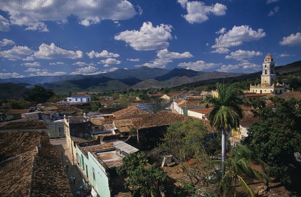 CUBA, Trinidad, View across red tiled city rooftops towards Iglesia San Franciso de Paula bell tower.