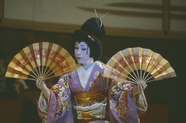 JAPAN, Honshu, Tokyo, Performer in play using fans.