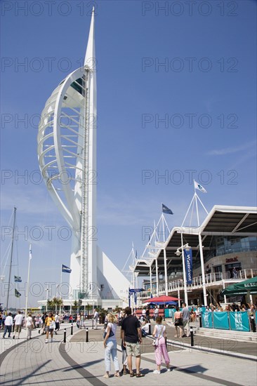 ENGLAND, Hampshire, Portsmouth, The Spinnaker Tower the tallest public viewing platforn in the UK at 170 metres on Gunwharf Quay with people on the waterfront area