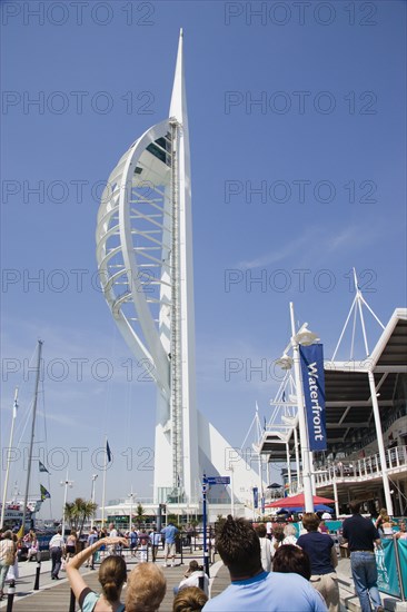 ENGLAND, Hampshire, Portsmouth, The Spinnaker Tower the tallest public viewing platforn in the UK at 170 metres on Gunwharf Quay with people on the waterfront area