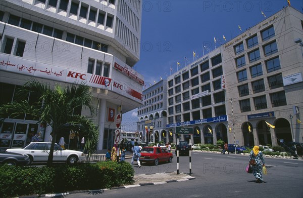 BRUNEI, Bandar Seri Begawan, Kentucky Fried Chicken in city centre opposite offices of Thai Airways and British Airways with passing traffic and pedestrians.