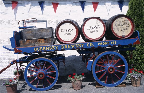 UNITED KINGDOM, Channel Islands, Guernsey, Forest Parish. German Occupation Museum. Brewery barrells and cart display outside main entrance.