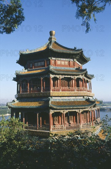 CHINA, Hebei, Beijing, The summer Palace framed by tree branches.