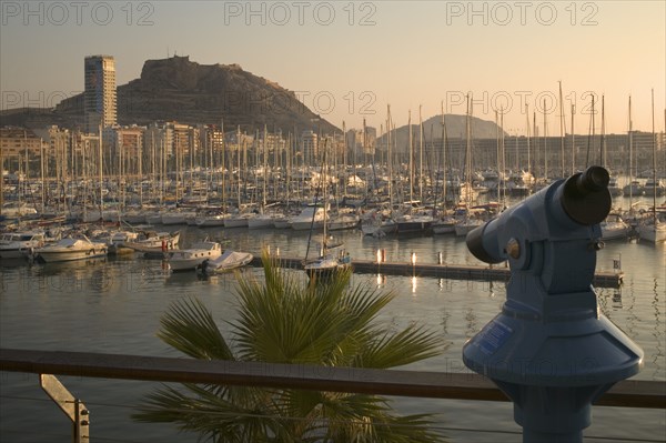 SPAIN, Costa Blanca, Alicante., View across the marina with a telescope in the foreground.