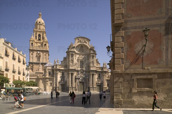SPAIN, Murcia, Cathedral de Santa Maria and Plaza del Cardenal Belluga with people walking past.