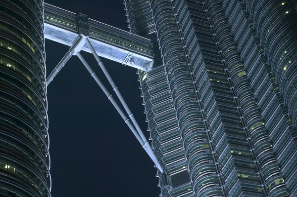 MALAYSIA, Peninsular, Kuala Lumpur,  Detail of the Petronis Towers at night showing walkway between the two towers.