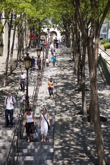 FRANCE, Ile de France, Paris, Montmartre People on the tree lined steps of the Rue Foyatier beside the Funiculaire cable car leading to the Church of Sacre Couer