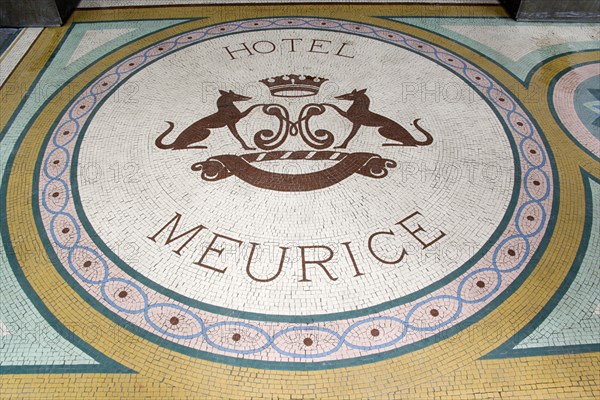 FRANCE, Ile de France, Paris, A mosaic with a crest and the words Hotel Meurice on the pavement outside the entrance door to the five star hotel in the Rue de Rivoli
