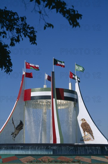 UAE, Abu Dhabi, Falcon Fountain with flags flying on top. Part of the Hotel Intercontinental